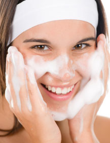 Teenager gently washing her face