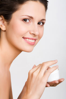 woman applying face moisturizer