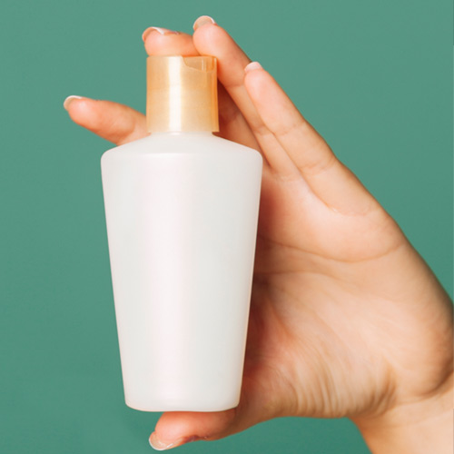 Female hand holding cosmetic product