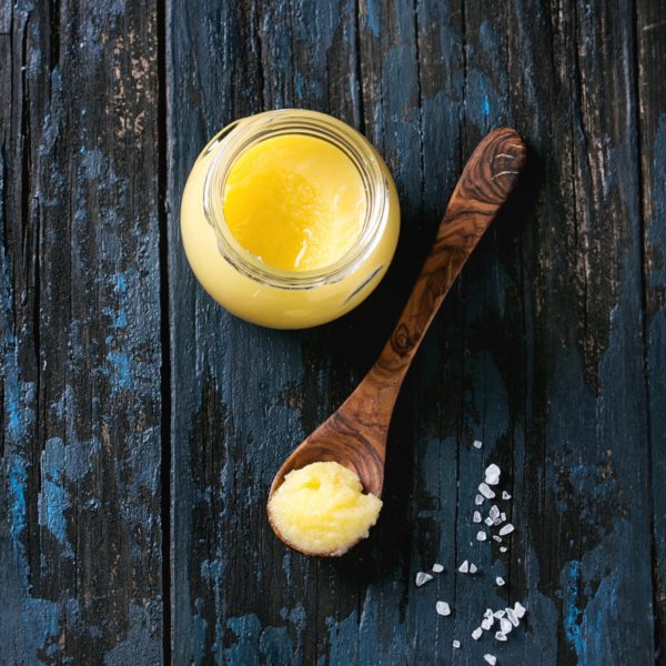 Ghee - Clarified Butter in a Jar and Spoon.