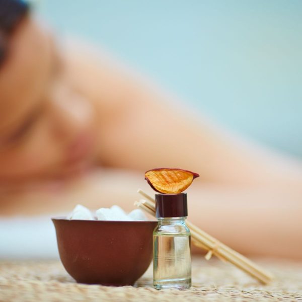 Woman enjoying relaxation massage with essential oils